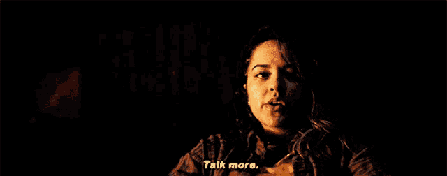 a woman in a plaid shirt says talk more