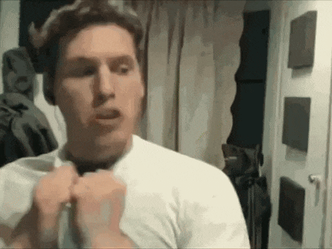 a man in a white shirt and tie is adjusting his tie .