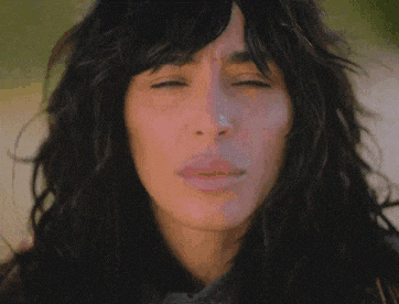 a close up of a woman 's face with long hair