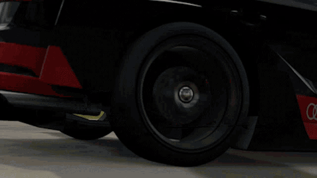 a black and red audi sport car with the number 1 on the side