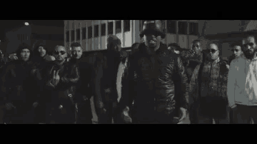 a group of men wearing leather jackets are standing together