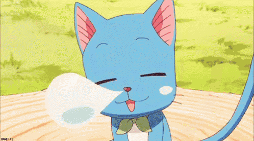 a blue cat with a bow tie is sitting on a log with its eyes closed