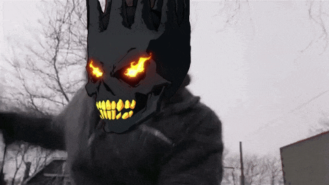 a person with a skull on their head with fire coming out of it