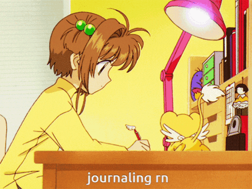 a girl sitting at a desk with the word journaling written on the table