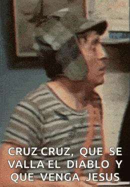 a man wearing a striped shirt and a hat says cruz cruz que se valla el diablo y que venga jesus .