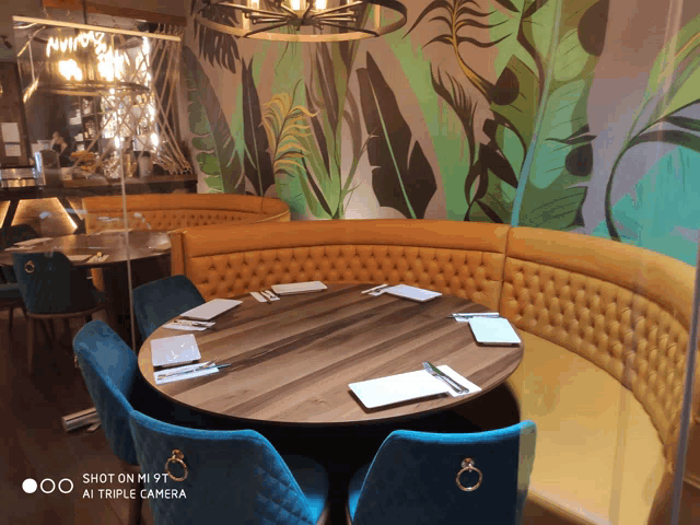 a round table in a restaurant with a shot on mi 9t triple camera