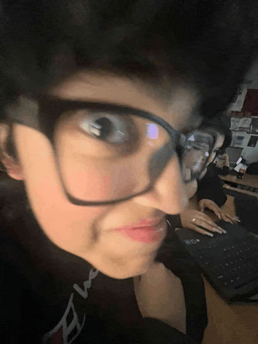 a close up of a person wearing glasses and a shirt that says e on it
