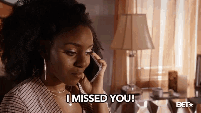 a woman talking on a cell phone with the words i missed you below her