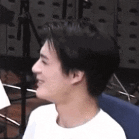 a man is sitting in a chair and smiling .