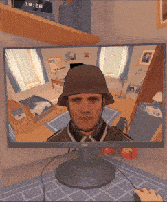 a computer monitor shows a man wearing a military helmet
