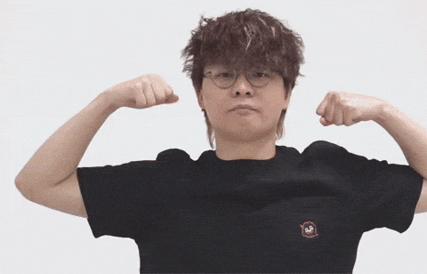 a man wearing glasses and a black shirt flexes his arms