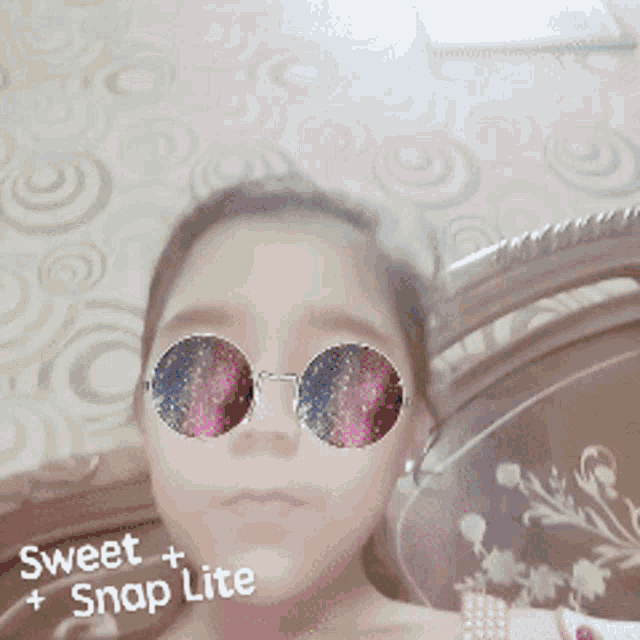 a girl wearing round sunglasses with the words sweet snap lite on the bottom right