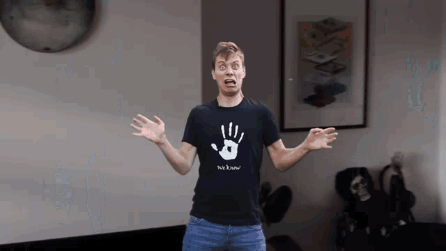 a man wearing a t-shirt that says " we know " on it