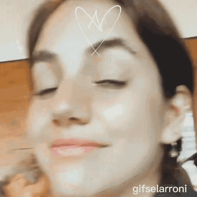 a close up of a woman 's face with a heart on her forehead