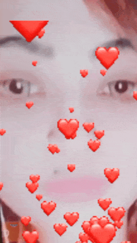 a woman 's face is surrounded by red hearts and the letter k is visible