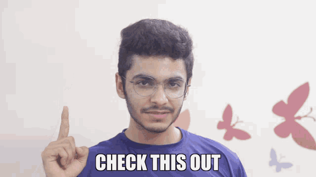 a man wearing glasses and a blue shirt with the words check this out written on it