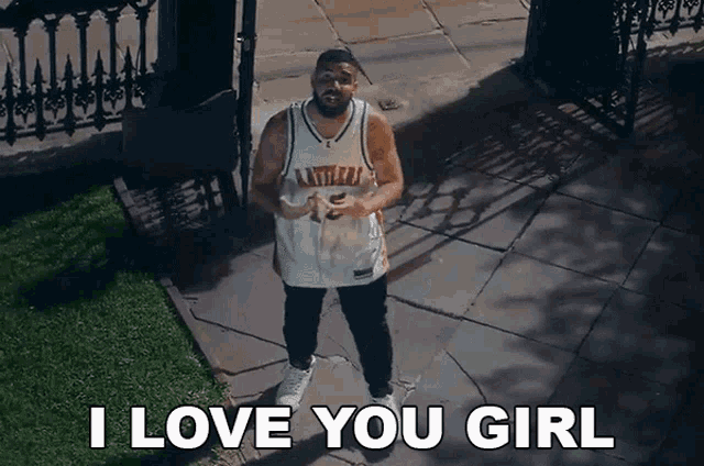 a man standing on a sidewalk with the words i love you girl above him
