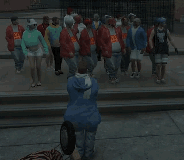 a man in a blue hoodie is standing in front of a group of people wearing mcdonald 's shirts
