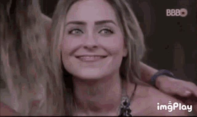 a woman is smiling with a bbbo logo in the background