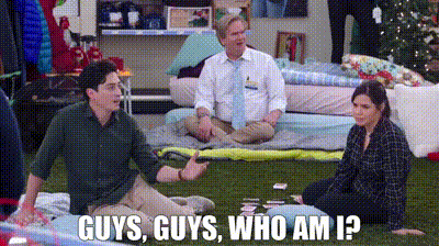 a group of people are sitting on the grass and one of them is asking , guys , guys , who am i .