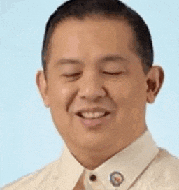 a man in a white shirt and tie is smiling with his eyes closed and his mouth open .