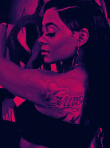 a woman with a tattoo on her arm is holding a wheel