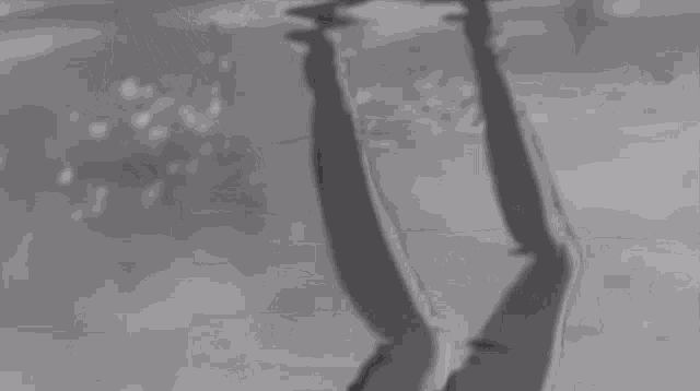 a black and white photo of a person falling down