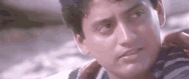 a close up of a man 's face with a serious expression .