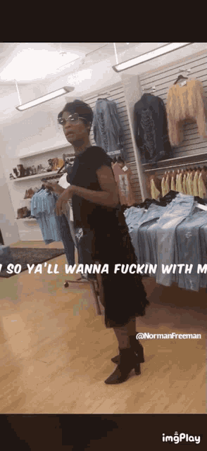 a woman in a black dress is standing in a clothing store with the words so ya 'll wanna fuckin with m