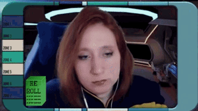 a woman is sitting in front of a screen that says " re roll "