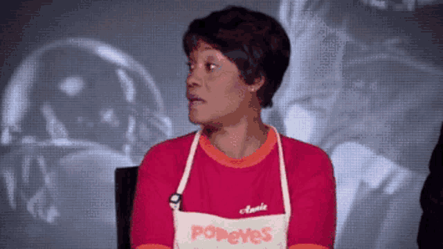 a woman wearing an apron with popeyes on it