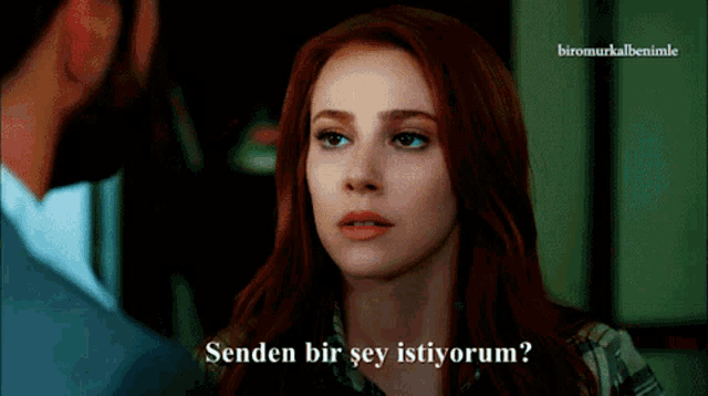 a woman with red hair is talking to a man and the words " senden bir şey istiyorum " are above her