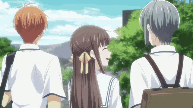 a girl with a yellow bow in her hair is laughing while standing next to two other people