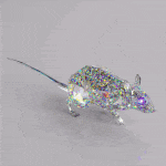 a mouse made of crystals is sitting on a table .