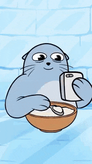 a cartoon seal is taking a picture of a heart in a bowl of food