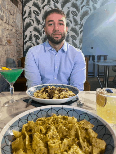 a man sits at a table with a plate of food