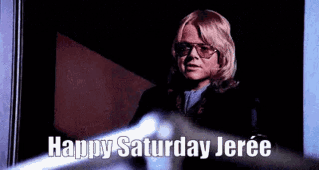 a woman wearing sunglasses and a wig is standing in front of a window and says `` happy saturday jeree '' .