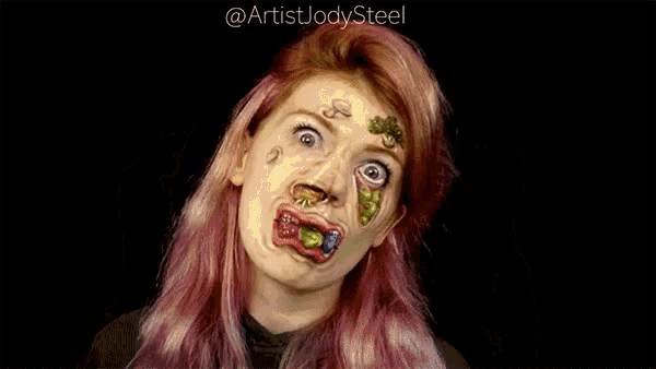 a woman with pink hair is making a funny face .