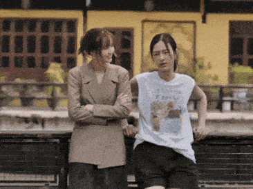 two women standing next to each other one wearing a t-shirt that says i love you