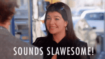 a woman is smiling while talking to a man and the words `` sounds slawesome '' are written on the screen .