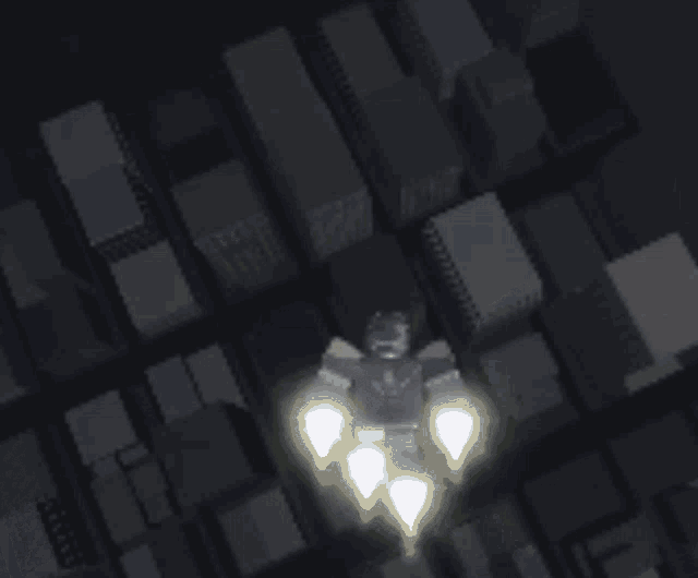 an aerial view of a city with a light coming out of the top of a building