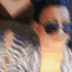 a blurry image of a person wearing sunglasses