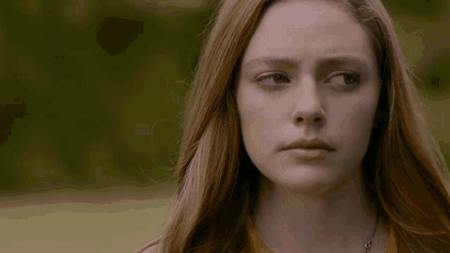 a close up of a woman 's face with her eyes closed