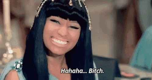 a woman with long black hair is smiling and laughing while wearing a crown .