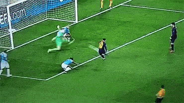 a group of soccer players are running on a field with a referee in the foreground