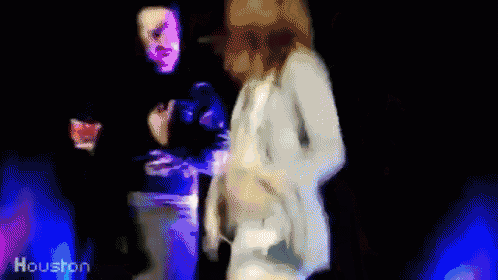 a blurry picture of a man and a woman dancing with the words houston in the corner