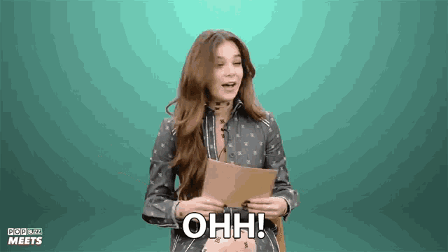 a woman holding a piece of paper with the words ohh written on it