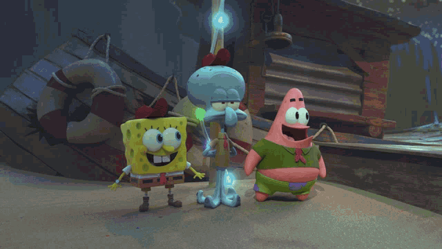 spongebob and patrick are standing next to each other on the beach