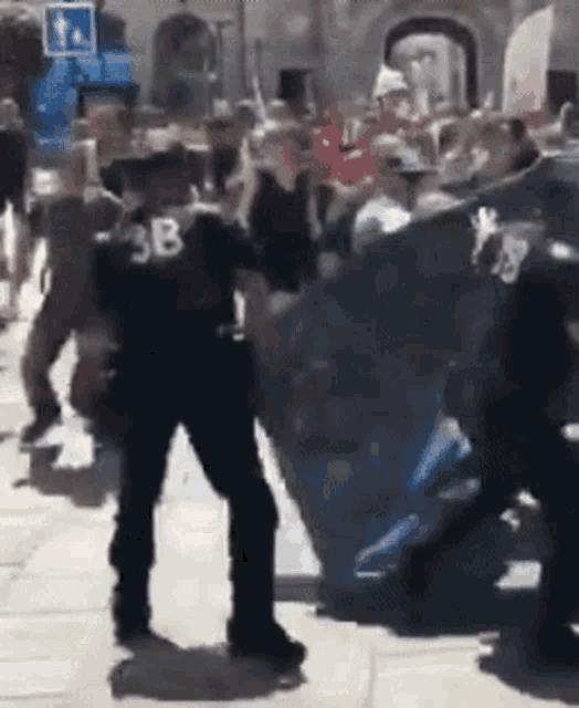 a blurred image of a police officer with the number 3b on his back