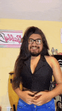 a man with a beard and glasses is wearing a black striped shirt